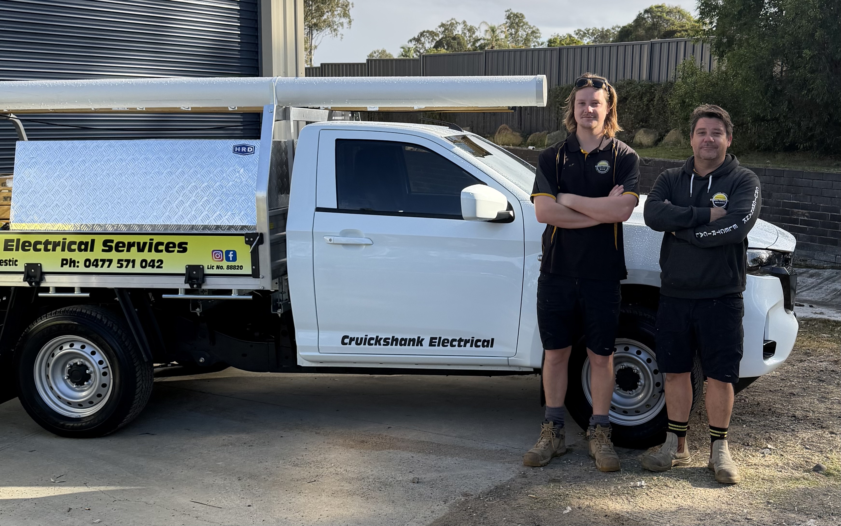 Cruickshank Electrical team beside a service vehicle